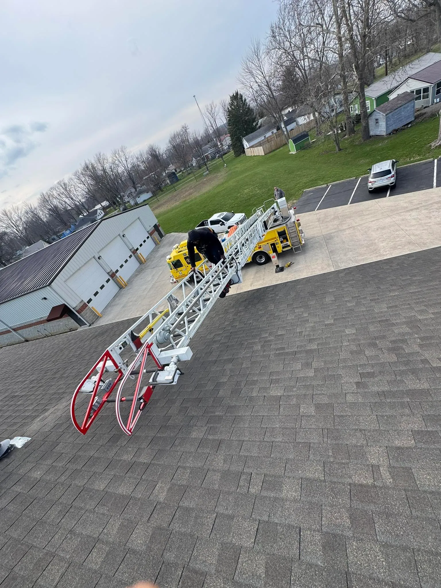 Roofer on a ladder at a job site
