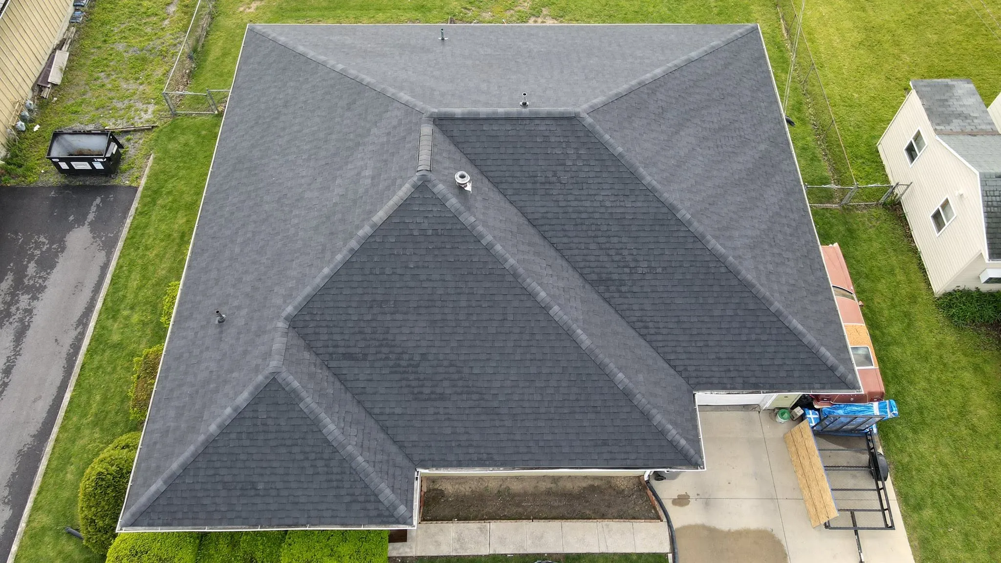 Drone view of a new dark gray hip roof in Logan County, Ohio